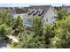 Aerial view of a traditional home with a brown roof, a double porch, and mature trees at 1658 Pierce St, Charleston, SC 29492