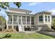 Charming home featuring a screened-in porch, a well-manicured lawn and mature landscaping at 1658 Pierce St, Charleston, SC 29492