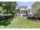 Lovely backyard featuring a screened-in porch, lush lawn, and mature trees. Perfect for outdoor enjoyment at 1658 Pierce St, Charleston, SC 29492