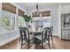 Dining area with modern lighting, large windows, and a view of the backyard at 1658 Pierce St, Charleston, SC 29492