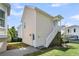 Back of home featuring yard, green lawn, stairs to upper floor, and exterior door at 1658 Pierce St, Charleston, SC 29492