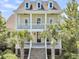 Beautiful two-story home with a double porch, grand staircase, and mature palm trees at 1658 Pierce St, Charleston, SC 29492