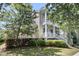 Charming two-story home with a double porch, beautiful landscaping, and mature trees at 1658 Pierce St, Charleston, SC 29492