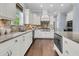 Bright kitchen featuring granite counters, stainless steel appliances, tile backsplash, and white cabinetry at 1658 Pierce St, Charleston, SC 29492