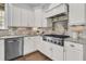 Kitchen features granite countertops, stainless steel appliances, tile backsplash, and white cabinets at 1658 Pierce St, Charleston, SC 29492