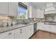 Kitchen area features granite countertops, stainless steel appliances, a sink with a window, and tile backsplash at 1658 Pierce St, Charleston, SC 29492