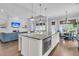Open-concept kitchen with large island, granite countertops, and stainless steel appliances connects to the living room at 1658 Pierce St, Charleston, SC 29492