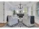 Cozy seating area with a round coffee table, overhead chandelier, and neutral color palette at 1658 Pierce St, Charleston, SC 29492