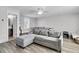 Spacious living room with wood floors, a comfortable gray couch, and a doorway to the bathroom at 1658 Pierce St, Charleston, SC 29492