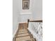 Carpeted staircase with white railings and hardwood steps leads to the upper level at 1658 Pierce St, Charleston, SC 29492