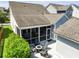 A well-maintained backyard featuring a screened porch and a cozy fire pit with Adirondack chairs at 1722 Winfield Way, Charleston, SC 29414