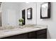 Bathroom with double granite vanity, dark wood cabinetry and decorative mirrors, adding a touch of elegance at 1722 Winfield Way, Charleston, SC 29414