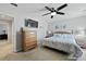Bedroom with ceiling fan, flat screen tv above dresser, queen sized bed, and ensuite bath at 1722 Winfield Way, Charleston, SC 29414