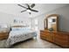 Bright bedroom with queen-sized bed, ceiling fan, a wooden dresser with mirror, and natural light at 1722 Winfield Way, Charleston, SC 29414