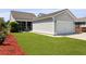Exterior view featuring an attached garage, screened in porch, and a well-maintained lawn at 1722 Winfield Way, Charleston, SC 29414