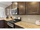 Modern kitchen features stainless steel appliances, granite countertops, and dark wood cabinets at 1722 Winfield Way, Charleston, SC 29414