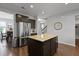 Spacious kitchen with a center island, stainless steel refrigerator, and hardwood floors at 1722 Winfield Way, Charleston, SC 29414