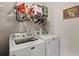 Functional laundry room featuring a washer, dryer, and storage shelves for supplies at 1722 Winfield Way, Charleston, SC 29414