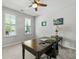 Bright office space with a ceiling fan, two windows and a large, traditional wooden desk at 1722 Winfield Way, Charleston, SC 29414