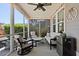 Relaxing screened porch with comfortable seating, ceiling fan, and a beverage fridge at 1722 Winfield Way, Charleston, SC 29414
