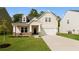 Charming home with a well-manicured lawn, stone accents, and a welcoming covered porch at 1730 Refuge Dr, Ladson, SC 29456