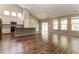 Open-concept living space with wood floors, bright windows, and a gourmet kitchen at 1730 Refuge Dr, Ladson, SC 29456