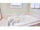 A luxurious soaking tub with jets and marble-like surround offers a relaxing experience in this spa-like bathroom at 1834 Cornish Ave, Charleston, SC 29412