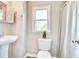 Cozy bathroom features a pedestal sink, toilet, and shower with a window view at 1834 Cornish Ave, Charleston, SC 29412