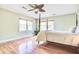 Bedroom with a four-poster bed, hardwood floors, ceiling fan, and plenty of natural light at 1834 Cornish Ave, Charleston, SC 29412