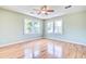 Spacious bedroom with hardwood floors, ceiling fan, neutral paint, and two large windows at 1834 Cornish Ave, Charleston, SC 29412