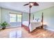 Bedroom with a four-poster bed, hardwood floors, ceiling fan, window, and green walls at 1834 Cornish Ave, Charleston, SC 29412