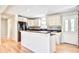 Bright kitchen featuring white cabinets, dark countertops, and an open design with hardwood floors at 1834 Cornish Ave, Charleston, SC 29412