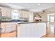Open-concept kitchen boasts granite counters, white cabinets, and an inviting breakfast bar at 1834 Cornish Ave, Charleston, SC 29412