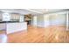 Open-concept space with hardwood floors that connects the living area, kitchen, and cozy fireplace at 1834 Cornish Ave, Charleston, SC 29412
