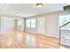Bright living room with hardwood floors, large windows, and a welcoming white front door at 1834 Cornish Ave, Charleston, SC 29412