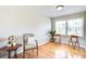 Cozy living room featuring hardwood floors, natural light, comfortable chair, and side table at 1834 Cornish Ave, Charleston, SC 29412