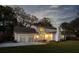 Exterior home elevation at dusk featuring a well-maintained lawn and an oversized driveway with garage at 19 Ponce De Leon Ave, Charleston, SC 29407