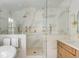Modern bathroom with a large glass shower, double vanity, and marble details at 19 Ponce De Leon Ave, Charleston, SC 29407