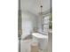 Bright bathroom with a luxurious tub, marble details, and a chandelier at 19 Ponce De Leon Ave, Charleston, SC 29407