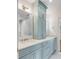 Charming bathroom featuring powder blue cabinets, marble countertops, and double sinks at 19 Ponce De Leon Ave, Charleston, SC 29407