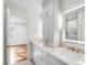Bright bathroom with double vanity, marble countertops, and access to a bedroom at 19 Ponce De Leon Ave, Charleston, SC 29407