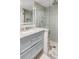 Stylish bathroom with a marble vanity, glass shower, and tiled walls at 19 Ponce De Leon Ave, Charleston, SC 29407
