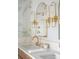 Modern bathroom with marble countertops and gold fixtures at 19 Ponce De Leon Ave, Charleston, SC 29407