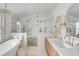 Bright bathroom with marble details, vanity, glass shower, and chandelier at 19 Ponce De Leon Ave, Charleston, SC 29407