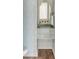 Stylish powder room with floral wallpaper, marble countertop and gold hardware at 19 Ponce De Leon Ave, Charleston, SC 29407