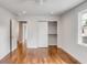 Bright bedroom featuring hardwood floors, neutral walls, and a closet at 19 Ponce De Leon Ave, Charleston, SC 29407