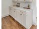 Bright white cabinetry with brass pulls and a white countertop adds a modern touch to the space at 19 Ponce De Leon Ave, Charleston, SC 29407