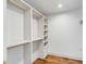 Custom closet with built in shelves and gold hardware at 19 Ponce De Leon Ave, Charleston, SC 29407