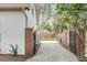 Side driveway with an entrance gate providing security and convenient access to the property at 19 Ponce De Leon Ave, Charleston, SC 29407
