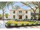 Beautiful two-story white brick home featuring a second-story balcony and landscaped front yard at 19 Ponce De Leon Ave, Charleston, SC 29407
